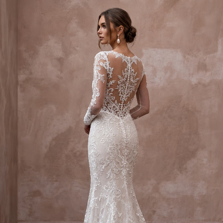 Lace wedding dress with long sleeves, sheer back, and trumpet silhouette