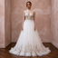 Tulle wedding dress with high neck, long sleeves, embroidered bodice, and full skirt