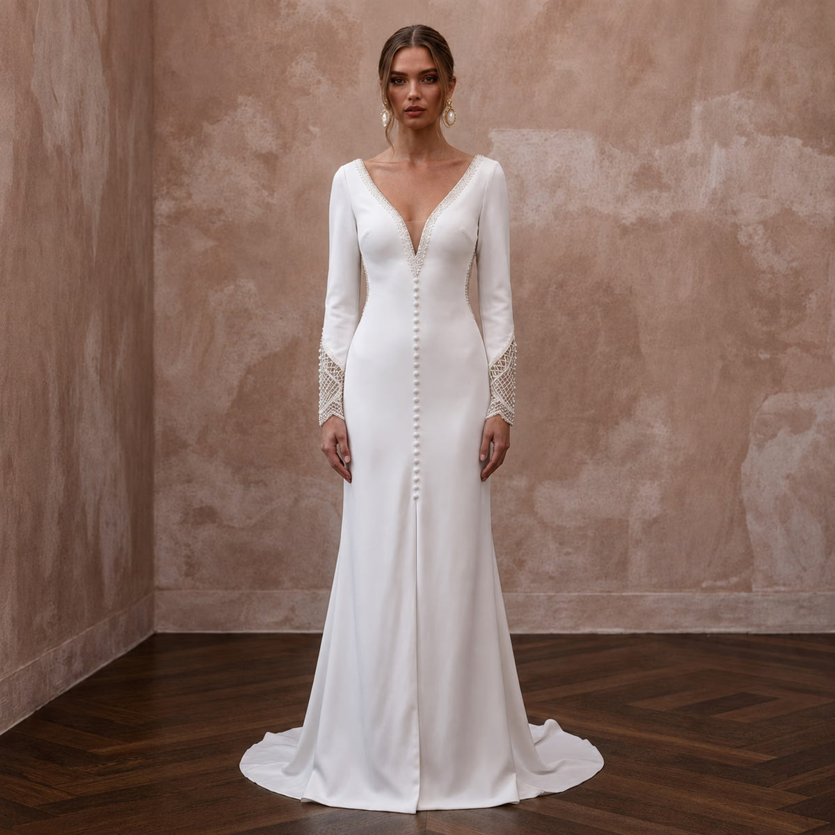 White crepe wedding dress with long sleeves, V-neck, buttoned front, scalloped trim