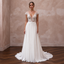 Elegant chiffon bridal dress with floral detailing and a sweep train, perfect for a tropical wedding.