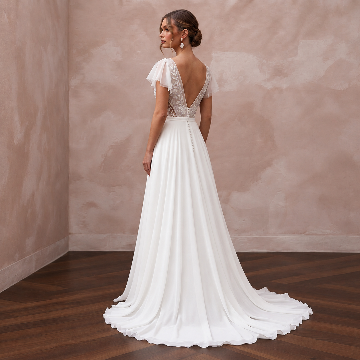 Elegant white chiffon wedding dress with a deep V-back and flowy sweep train, perfect for a beach ceremony.