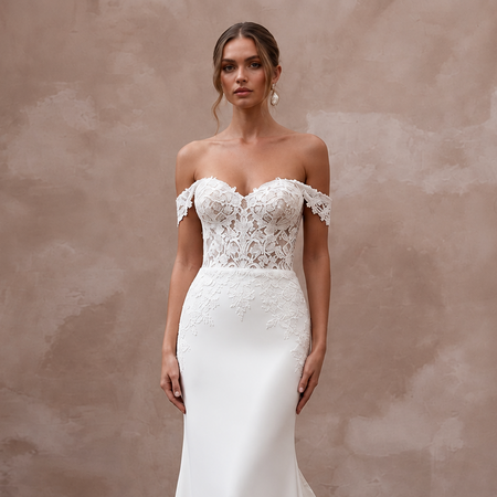 Off-the-shoulder sweetheart lace wedding gown with detachable train and intricate floral details.