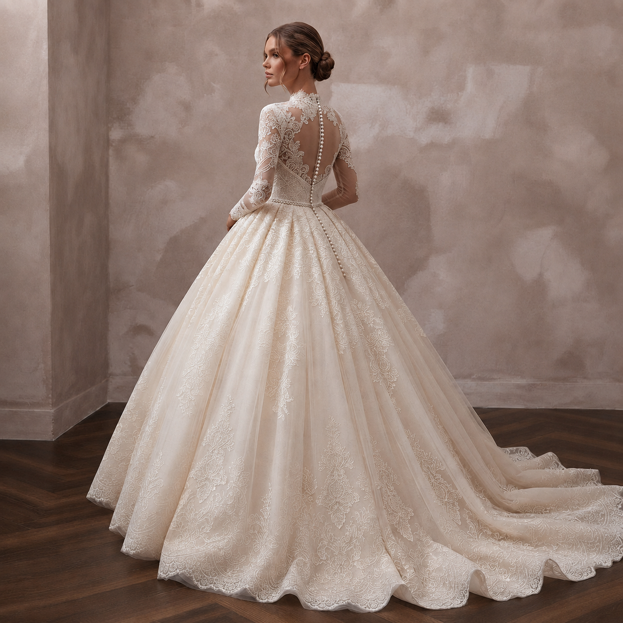 A woman wearing a voluminous ivory lace ball gown with long sleeves and a high neck, shown from the back in an indoor setting with a textured beige wall and dark wood floor.