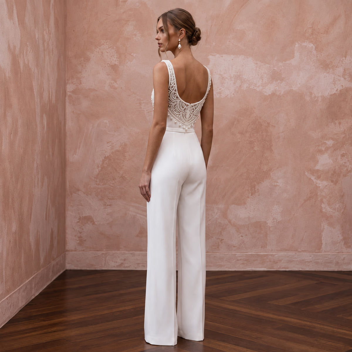 Elegant white stretch crepe jumpsuit with square neck and beaded back, perfect for courthouse weddings.